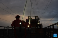 Workers clean catenary insulators along Qinghai-Xizang Railway in NW China