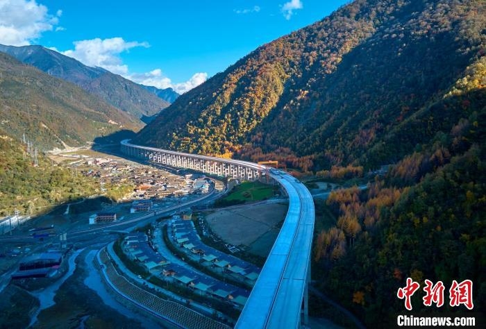 九綿高速宛若一條玉帶，點綴五彩斑斕的滿山彩林。　胡宇 攝