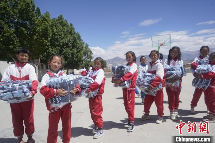 图为拉萨市空港新区甲日小学学生们拿到新校服合影。　贡嘎来松 摄