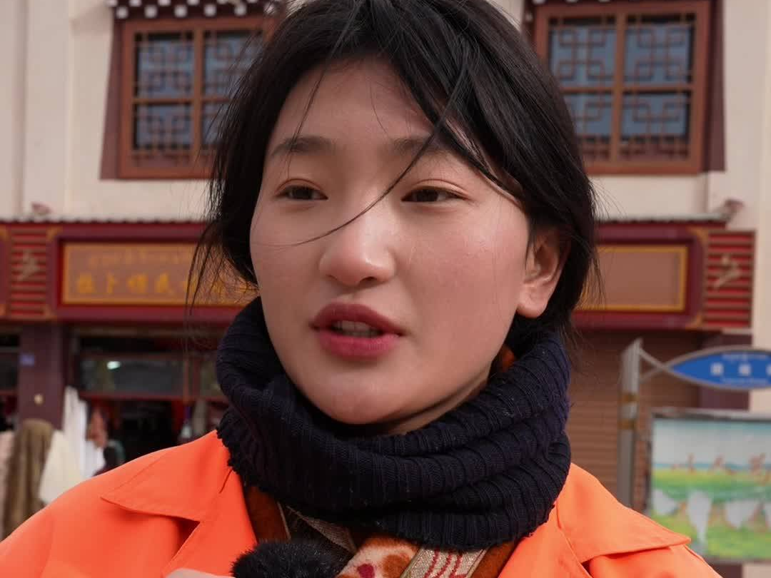 Young Tibetan holds to her position to ensure a clean festival for local people