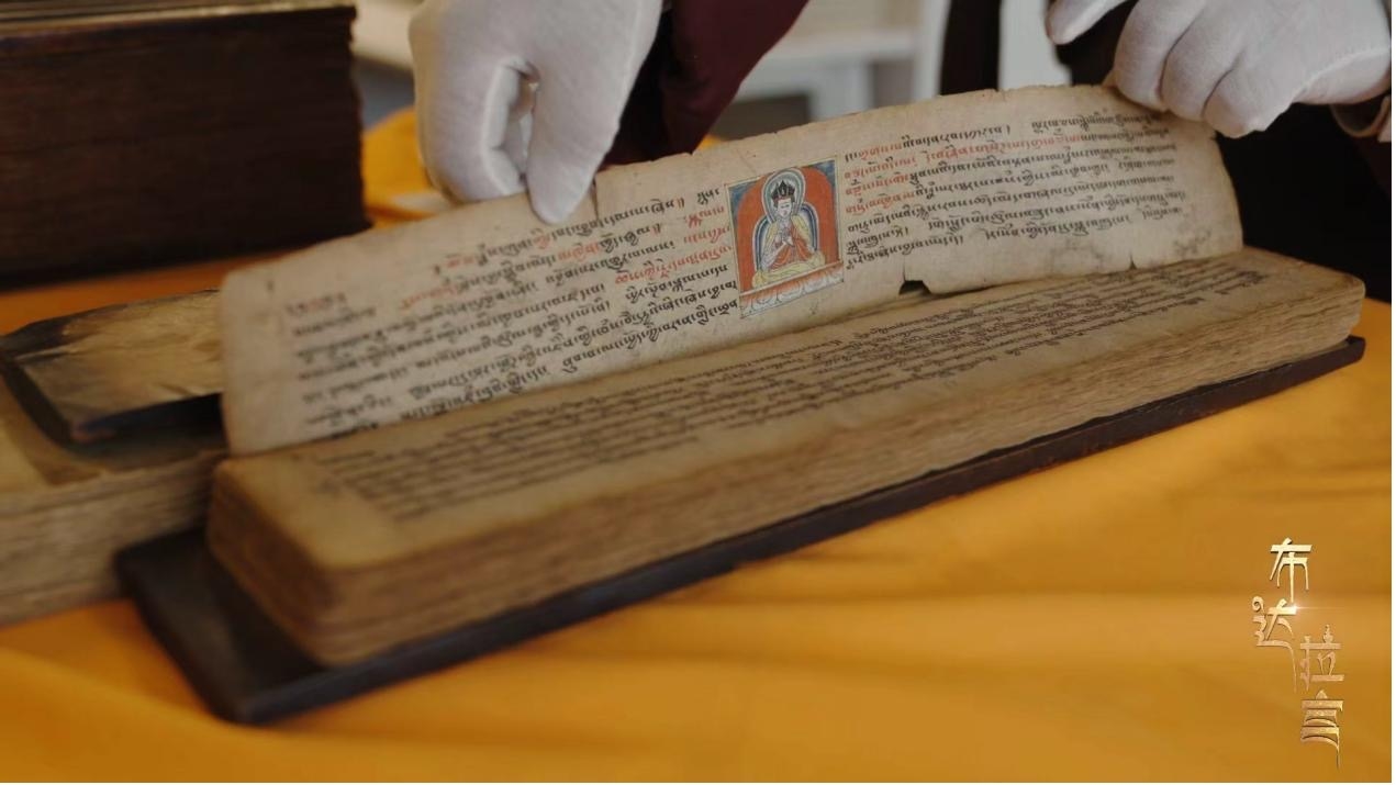Staff members display preserved rare ancient texts in the Ancient Texts Library at Nenang Monastery, Lhasa, southwest China's Xizang Autonomous Region. /CGTN