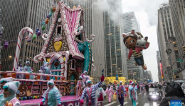 Feature: Spectators line up New York streets for Macy's Thanksgiving parade despite rain